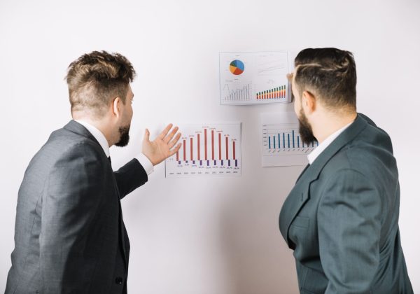 coworkers-watching-diagrams-wall